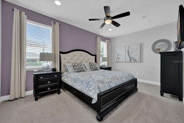 bedroom featuring a ceiling fan, recessed lighting, light colored carpet, and baseboards