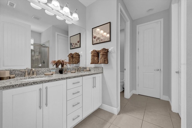 bathroom with visible vents, a sink, toilet, and tile patterned floors