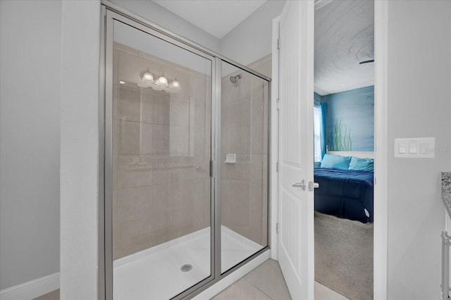 ensuite bathroom with a shower stall, tile patterned flooring, and ensuite bathroom