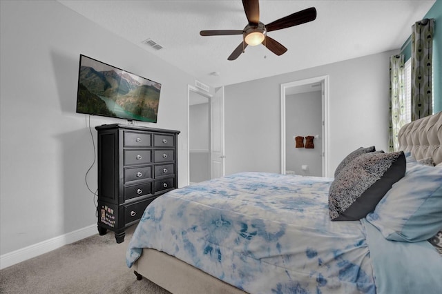 carpeted bedroom with a ceiling fan, visible vents, and baseboards