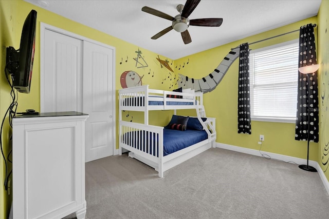 unfurnished bedroom with light carpet, a closet, baseboards, and a ceiling fan