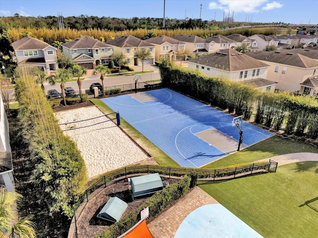 view of sport court with a lawn, a residential view, fence, community basketball court, and volleyball court