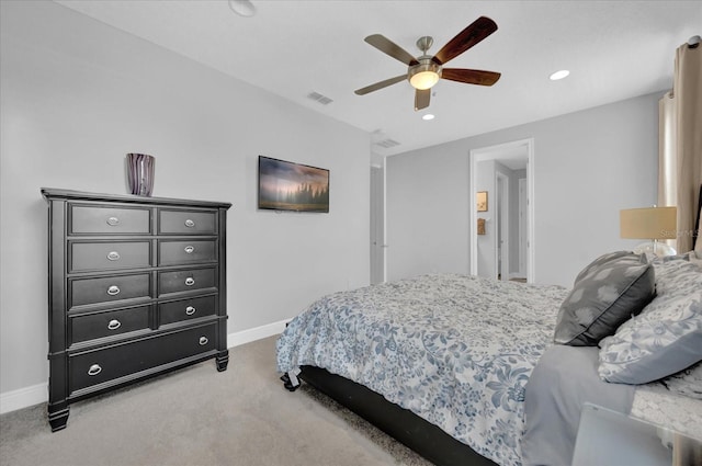 bedroom with baseboards, ceiling fan, visible vents, and light colored carpet