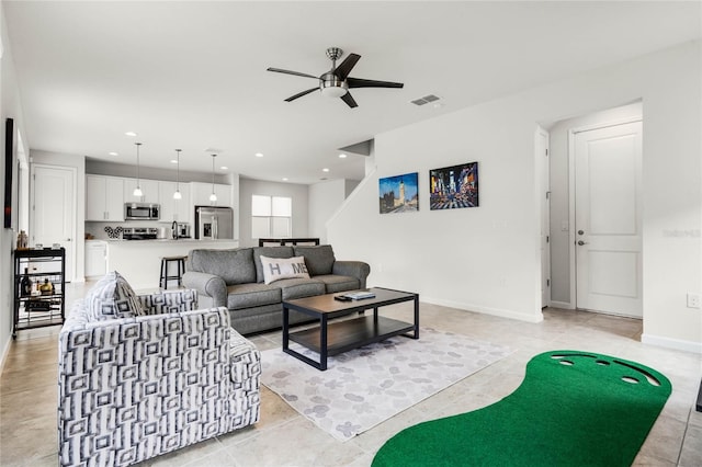 living room with baseboards, ceiling fan, visible vents, and recessed lighting