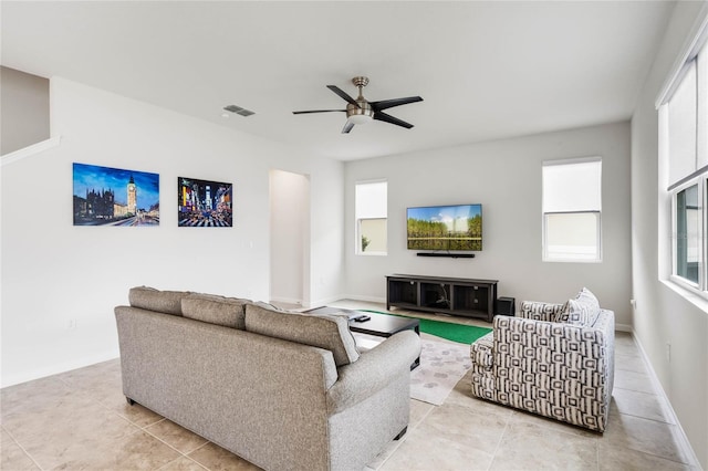 living room with visible vents, ceiling fan, baseboards, and light tile patterned floors