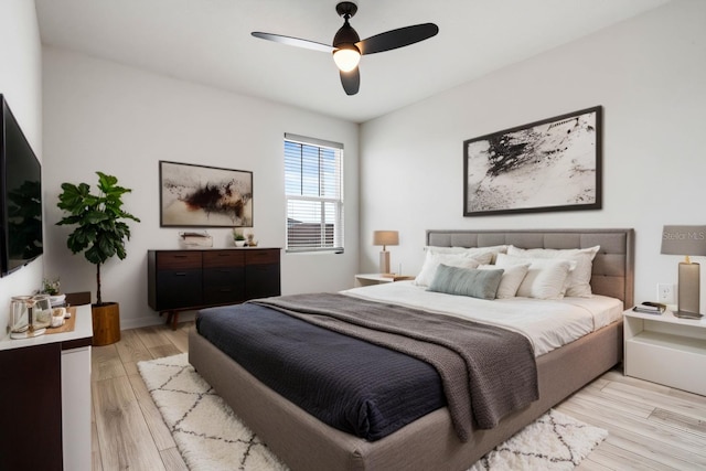 bedroom with light wood-type flooring and a ceiling fan