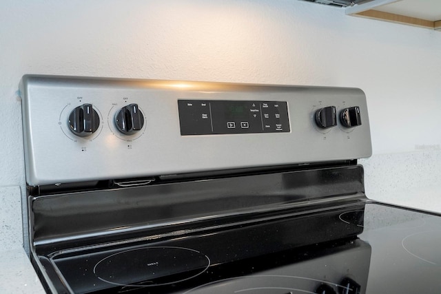 interior details with stainless steel range with electric stovetop and a mail area