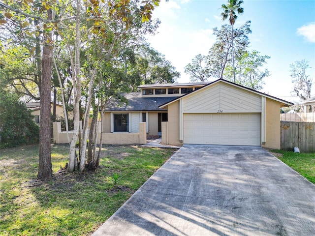 mid century modern featuring fence, a front yard, concrete driveway, and a garage