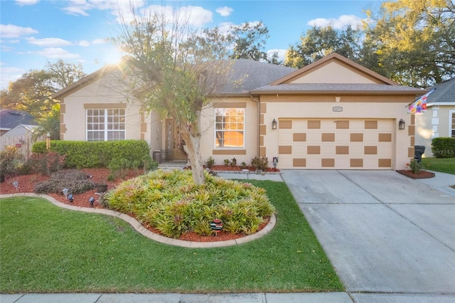 ranch-style house featuring an attached garage, concrete driveway, a front yard, and stucco siding