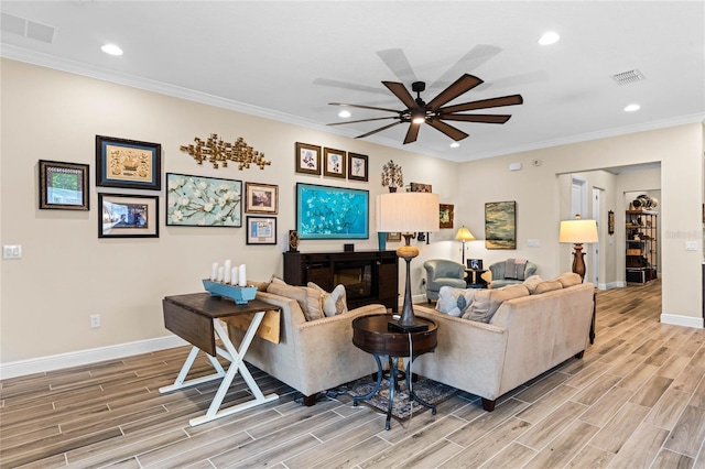 living area featuring ceiling fan, ornamental molding, visible vents, and wood tiled floor