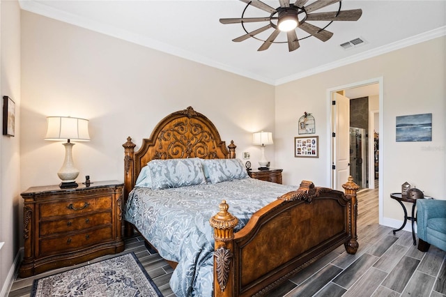 bedroom with wood tiled floor, visible vents, crown molding, and baseboards