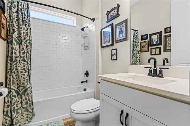 full bathroom featuring toilet, shower / bath combo with shower curtain, wood finished floors, and vanity