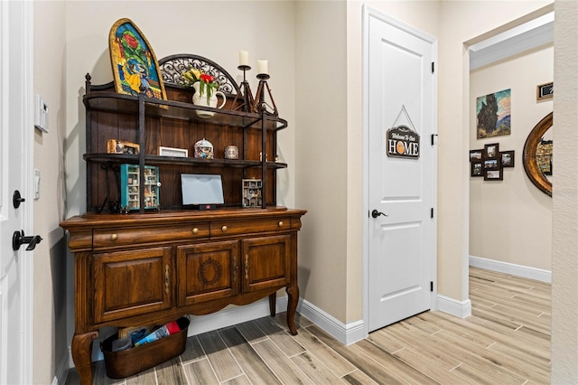 interior space featuring baseboards and wood tiled floor