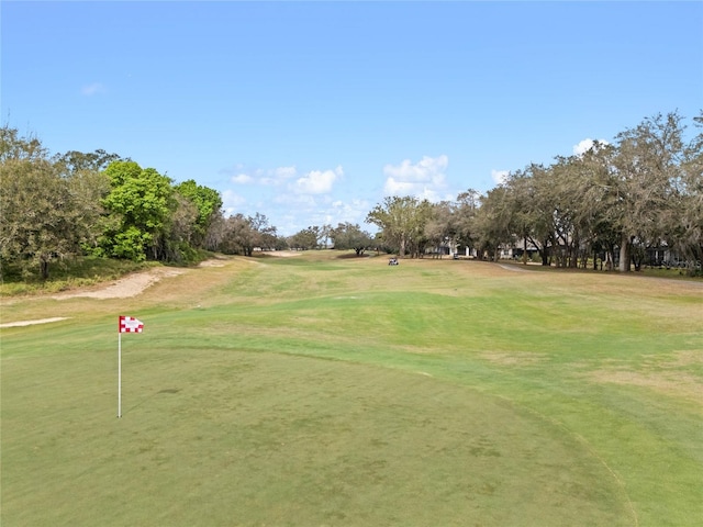 view of property's community with a yard and golf course view