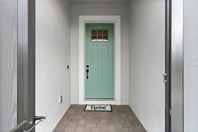 property entrance featuring stucco siding