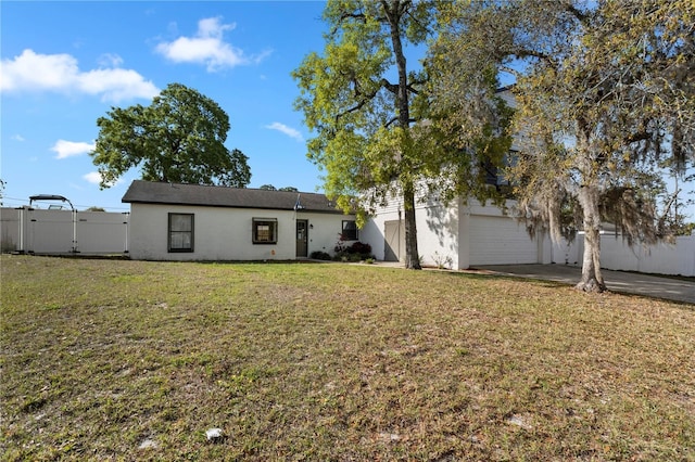 2531 Ludlow St, Deltona, FL 32738 - view of front of home featuring stucco siding, a front yard, fence, a gate, and a garage