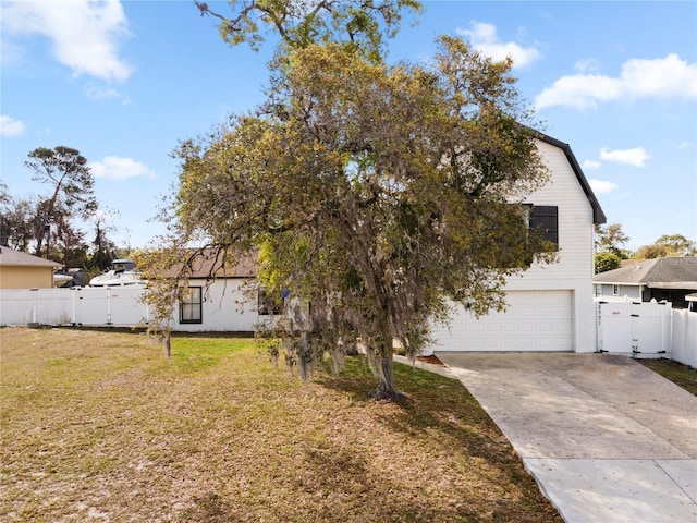 2531 Ludlow St, Deltona, FL 32738 - view of front of house with a gate, driveway, a front yard, a garage, and fence
