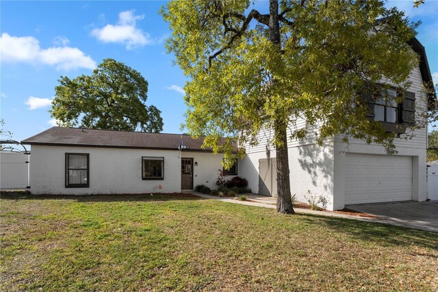 2531 Ludlow St, Deltona, FL 32738 - view of front of property with a garage, a front yard, driveway, and stucco siding