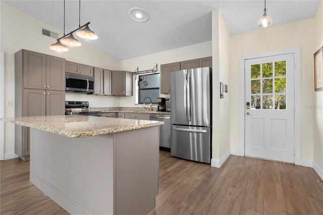 2531 Ludlow St, Deltona, FL 32738 - kitchen with visible vents, hanging light fixtures, dark wood-style flooring, appliances with stainless steel finishes, and gray cabinetry
