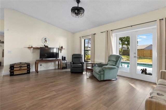 2531 Ludlow St, Deltona, FL 32738 - living area with french doors, vaulted ceiling, wood finished floors, and a textured ceiling