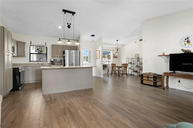 2531 Ludlow St, Deltona, FL 32738 - kitchen with a kitchen island, gray cabinets, appliances with stainless steel finishes, lofted ceiling, and dark wood-style floors