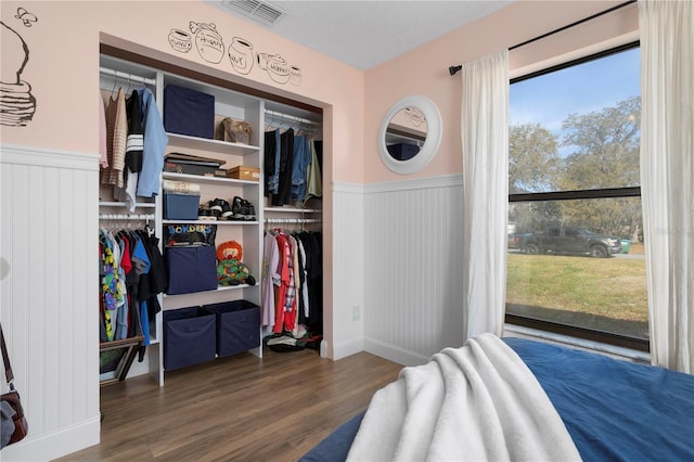2531 Ludlow St, Deltona, FL 32738 - bedroom with wood finished floors, a closet, wainscoting, and visible vents