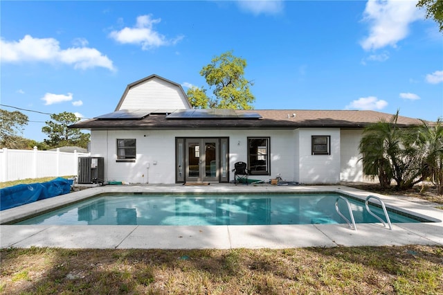 2531 Ludlow St, Deltona, FL 32738 - rear view of house featuring a fenced in pool, french doors, central AC, concrete block siding, and fence