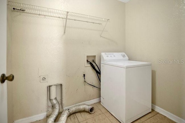 laundry room with baseboards, washer / clothes dryer, light tile patterned floors, and laundry area