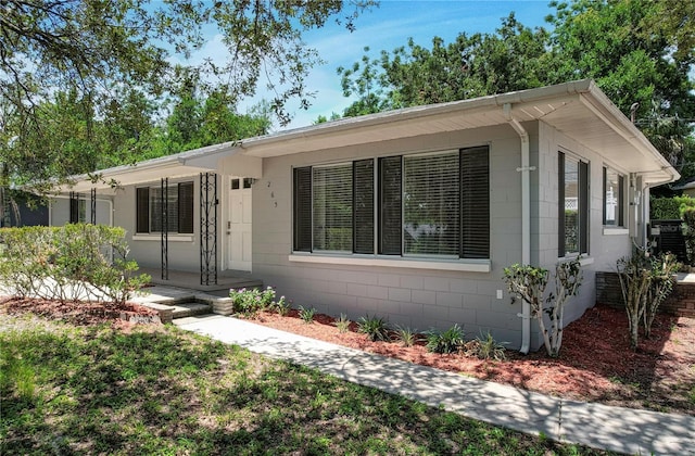 ranch-style house featuring concrete block siding