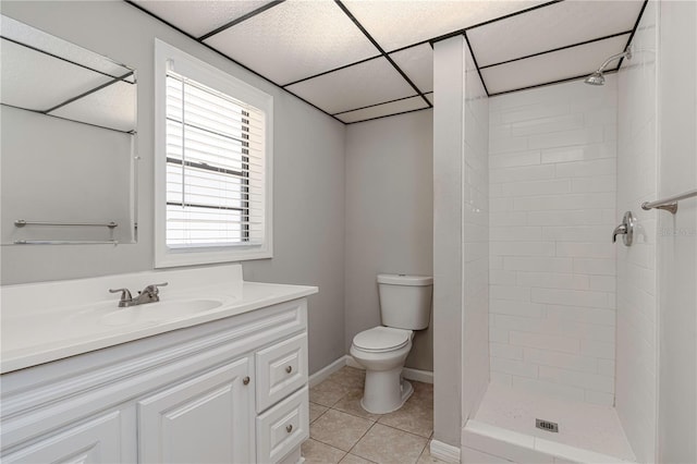 bathroom featuring vanity, a shower stall, baseboards, toilet, and tile patterned floors