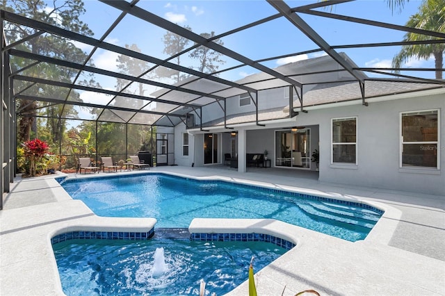 view of swimming pool with ceiling fan, a patio, a lanai, and a pool with connected hot tub