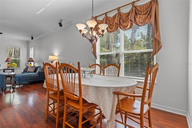 dining area with a chandelier, baseboards, dark wood finished floors, and ornamental molding