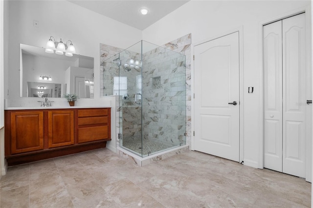 full bathroom with vanity, a shower stall, and a chandelier