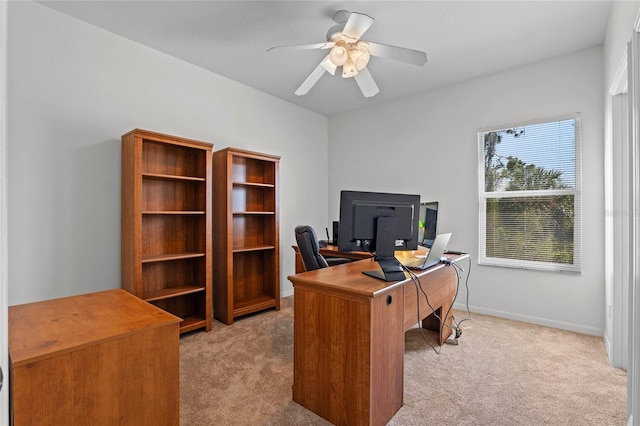 office with baseboards, light carpet, and a ceiling fan