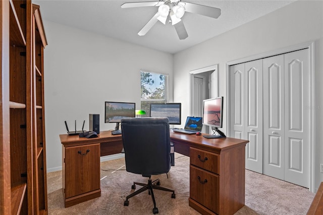 carpeted office featuring ceiling fan