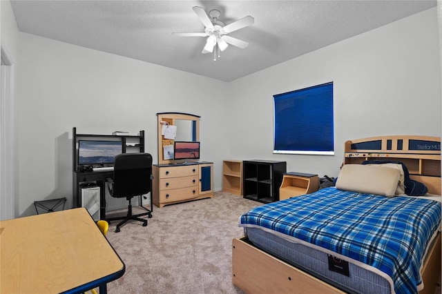 carpeted bedroom with ceiling fan and a textured ceiling