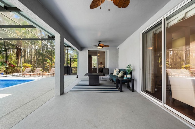 view of patio featuring an outdoor living space, glass enclosure, an outdoor pool, and a ceiling fan