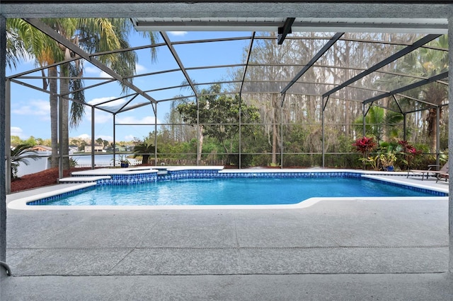 pool with a lanai and a patio area