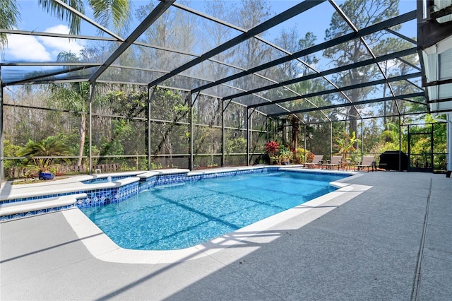 view of pool featuring a lanai, a patio area, and a pool with connected hot tub