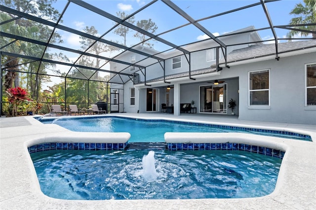 pool with glass enclosure, an in ground hot tub, and a patio