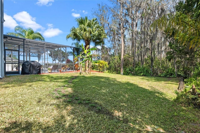 view of yard with glass enclosure