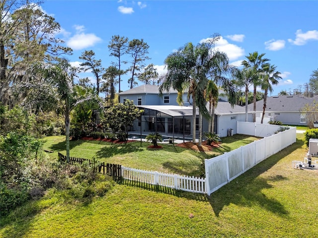 view of yard featuring glass enclosure, a swimming pool, and a fenced backyard