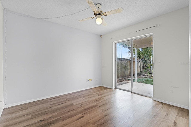 unfurnished room with a textured ceiling, a ceiling fan, baseboards, and light wood-type flooring