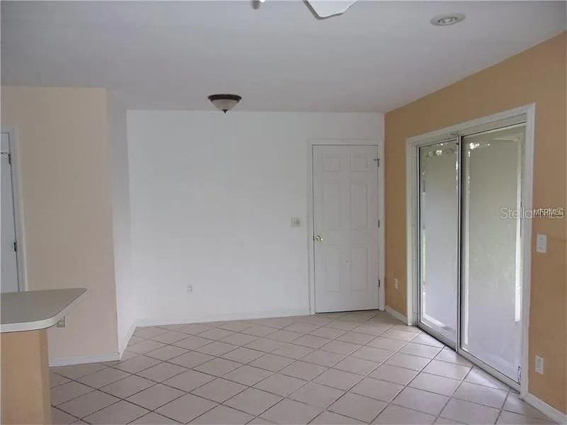 unfurnished room featuring baseboards and light tile patterned flooring