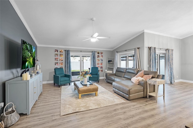 living room with ornamental molding, lofted ceiling, baseboards, and light wood finished floors