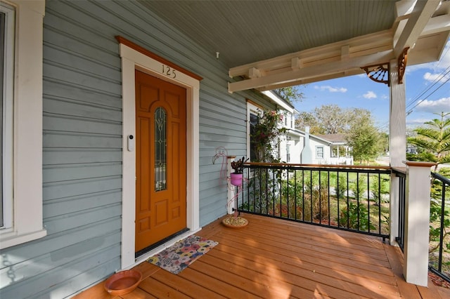 view of exterior entry with covered porch