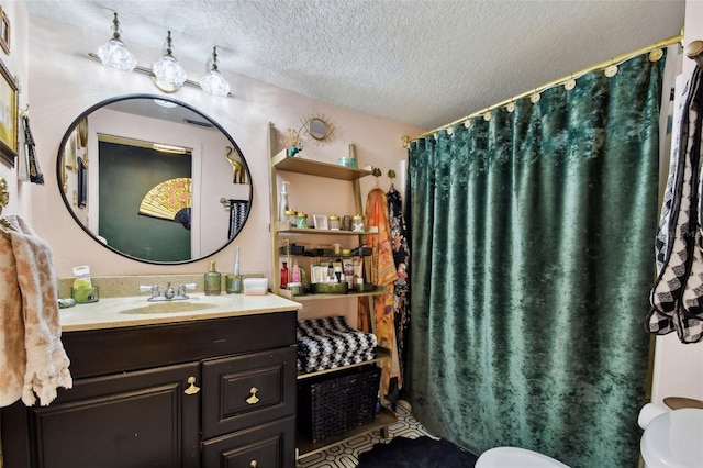 full bath featuring a textured ceiling, toilet, and vanity