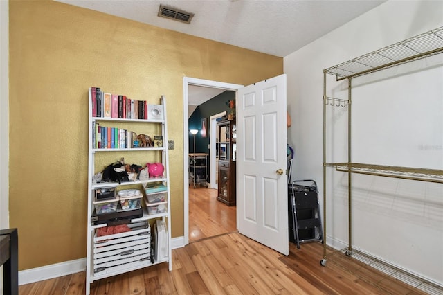 interior space featuring visible vents and wood finished floors