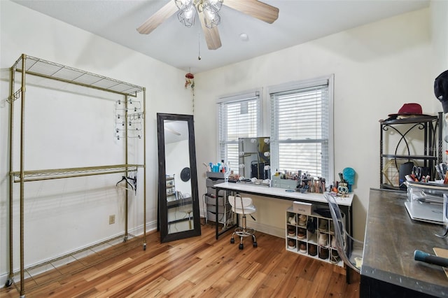 office featuring baseboards, a ceiling fan, and wood finished floors