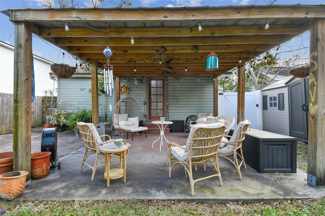 view of patio / terrace with fence and ceiling fan